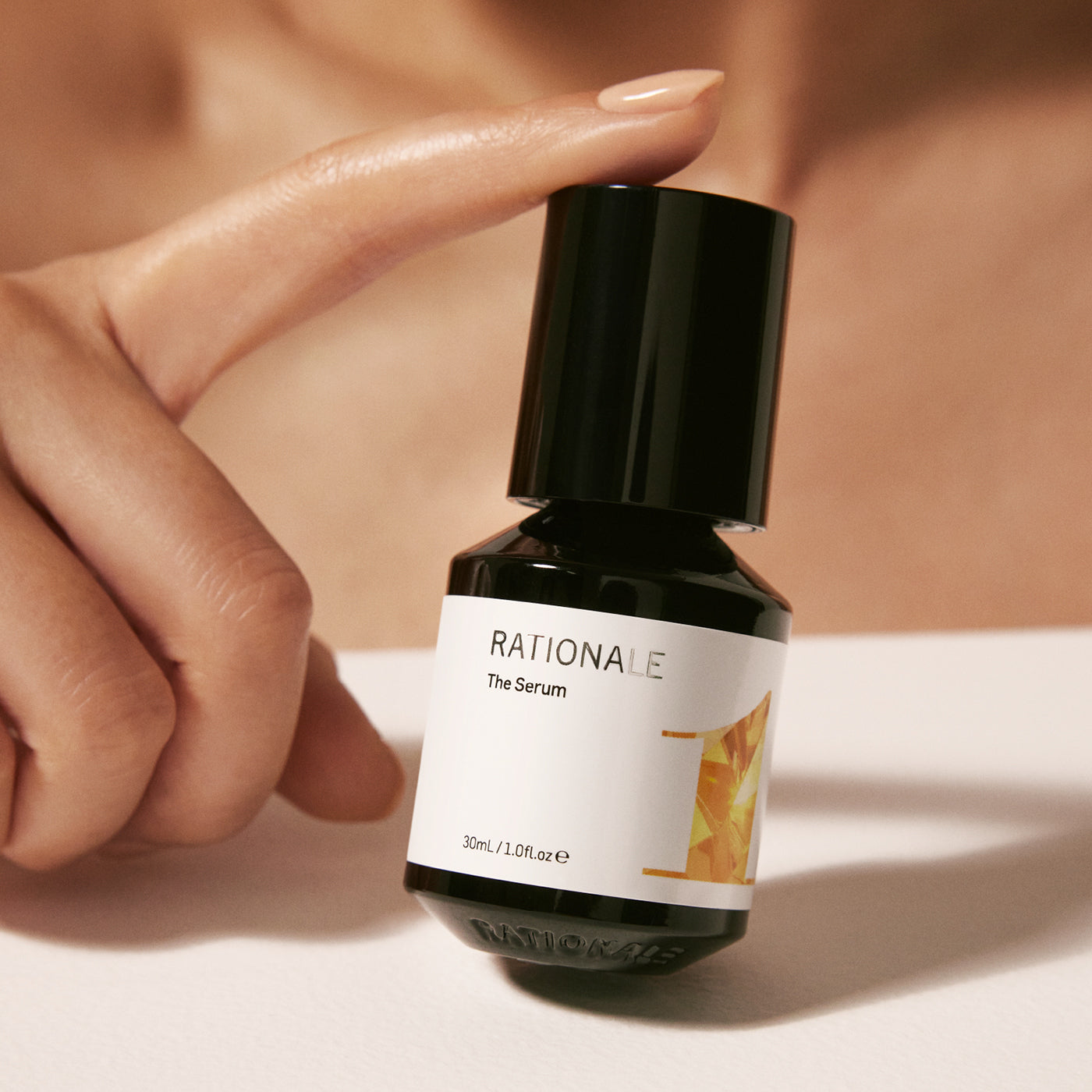 #1 The Serum formulation in bottle held by model.