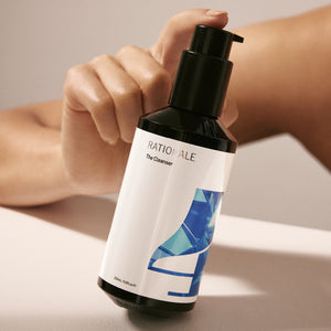 Model holding #4 The Cleanser pump bottle.